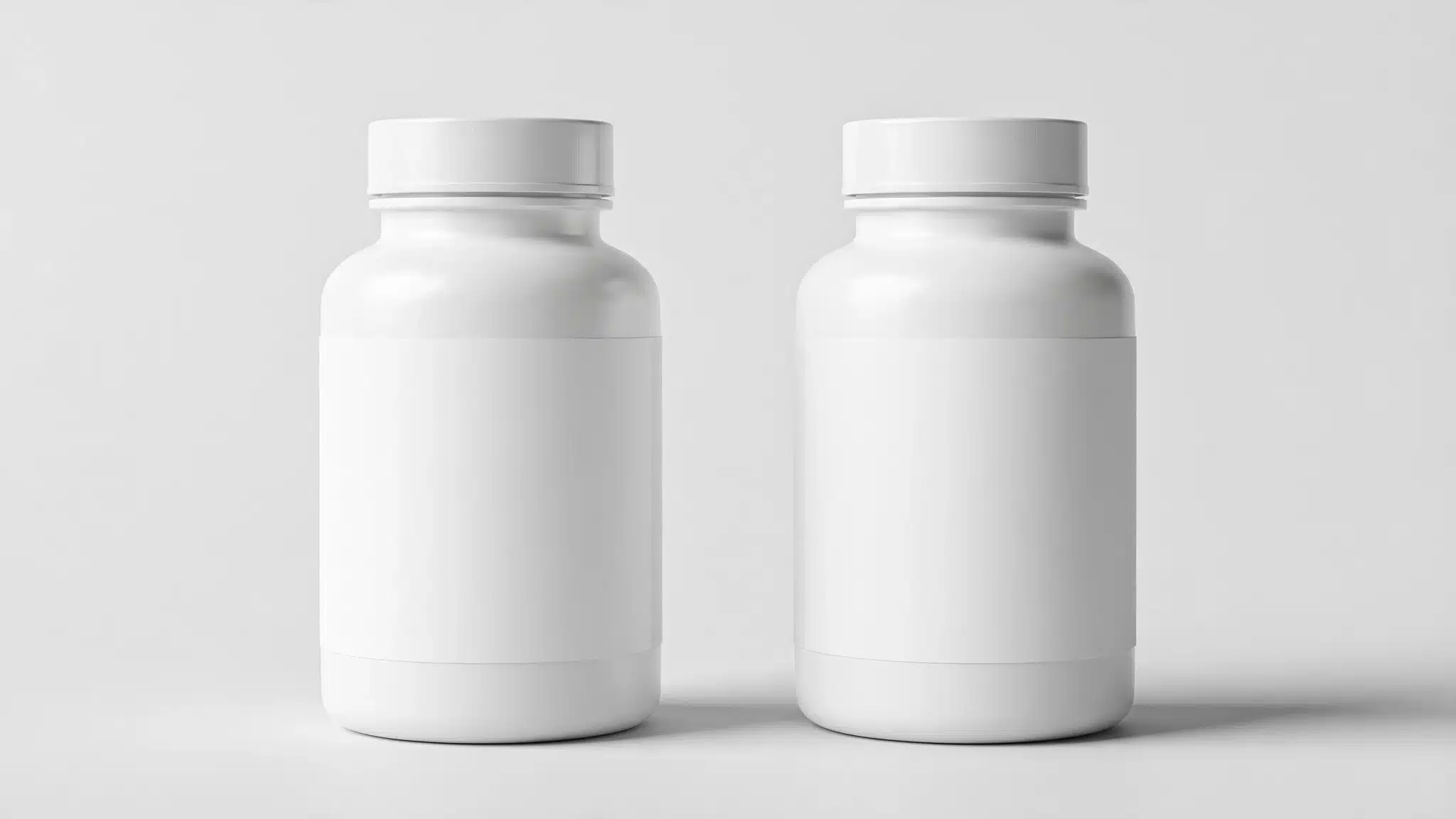 Row of plain white treatment bottles on a light surface